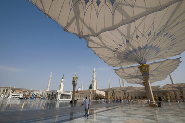 Pilgrims walk underneath giant umbrellas at Nabawi Mosque compound  in Medina, Kingdom of Saudi...