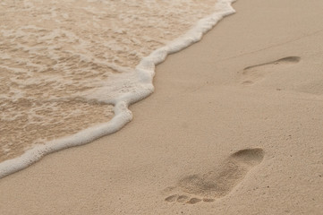 Steps on the beach. Footprint in the sand