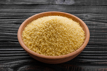 fresh couscous on a wooden rustic background