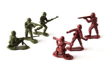 A war battle of toy soldiers, isolated on white background