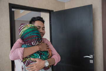 muslim woman and man hugging