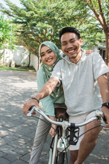 muslim couple riding a bike
