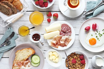 
    Breakfast food table. Brunch set, meal variety with fried egg, croissants, granola and fresh...