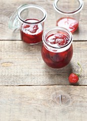 Strawberry marmalade. Homemade strawberry jam in glass jar overhead rustic wooden table. Copy space