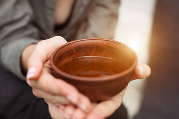 Closeup view of woman holding herbal cup of tea