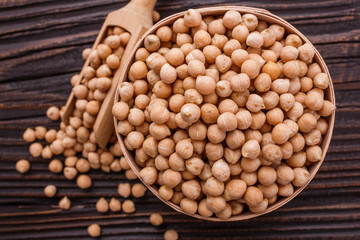 uncooked chickpeas on a wooden rustic background