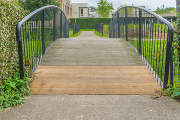 wooden and iron bridge walkway in the park front view