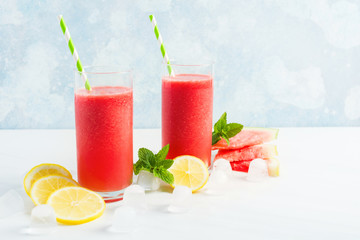 Two glass of fresh watermelon nonalcoholic mojito on blue background