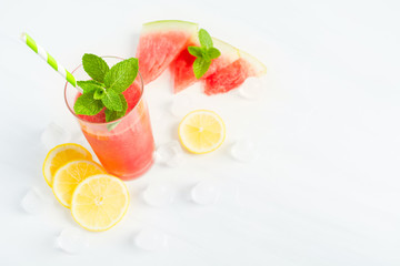 Fresh red watermelon mojito on white table with ingredients