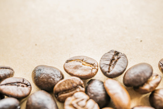 macro of coffee beans on rustic paper background