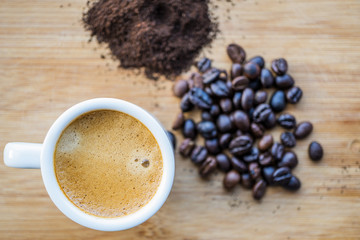 Cup of coffee, powder coffee and scoop on rusty background