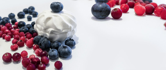 Blueberries and cranberries, berries on a white background. Berry light background.