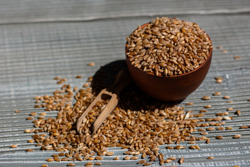spelt seeds on a wooden rustic background