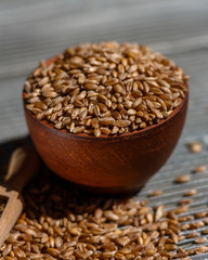 spelt seeds on a wooden rustic background