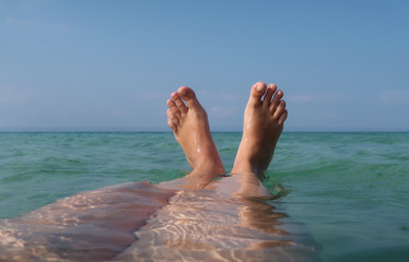 Fototapeta na wymiar Feet up in the sea