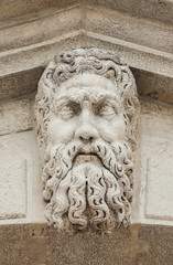 Bearded man white stone head at the top of Rialto Bridge in Venice (16th century)