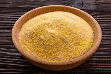 raw Italian corn porridge polenta on a rustic wooden background