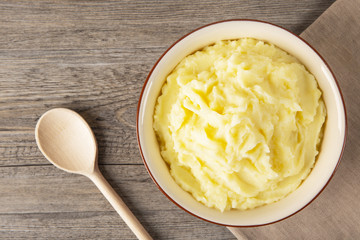 Puree from potatoes in a plate. Wooden background. Top Vieux. Macro.