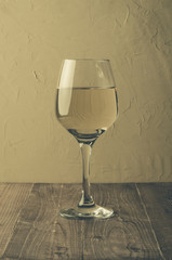 wine on wooden table/glass of white wine on a wooden table, selective focus