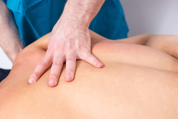 Obraz na płótnie Canvas Professional masseur applying pressure to muscles