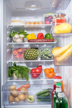 Open fridge full of fresh groceries