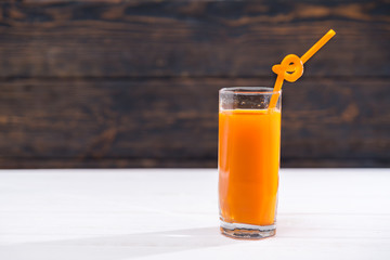 Glass of refreshing vegetable juice with straw