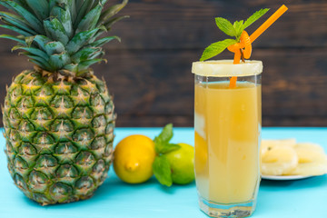 Fresh pineapple juice with whole fruit and lemons