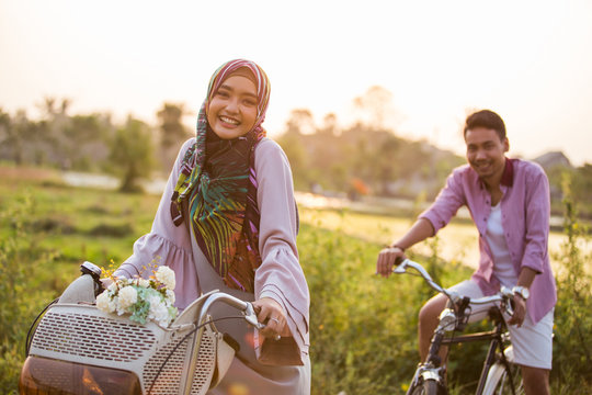 Muslim Couple Riding A Bike