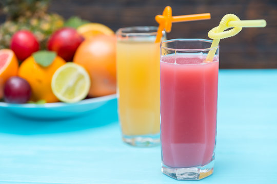 Tall glasses of healthy fresh squeezed fruit juice
