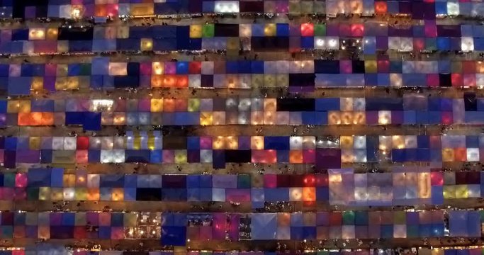 Time-lapse view of the colorful market, traditional Train Night Market Ratchada and the Neon Train Market in Bangkok, Thailand, captured by drone footage.