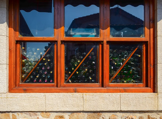 Window of a warehouse of empty wine glass bottles