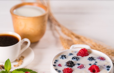 Bowl of breakfast cereal with milk and berries