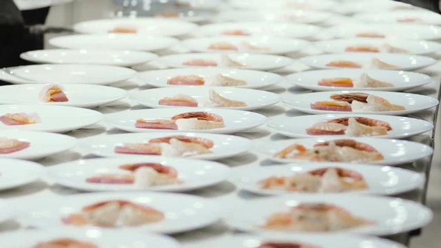 Chef preparing and decorating food, many round plates&nbsp;with meal in kitchen in restaurant
