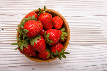 Juicy fresh strawberry on a rustic wooden background