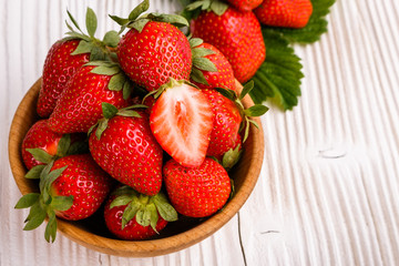 Juicy fresh strawberry on a rustic wooden background