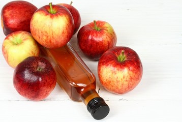 Apple vinegar in cut bottle / Fersh apples  around on white wooden table