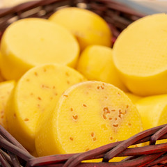 Cheese in basket. Head of delicious cheese.
