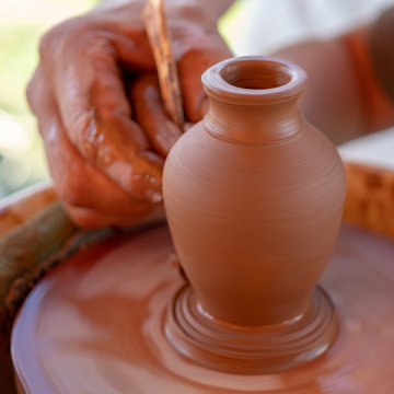 Potter make pot on potter's wheel.