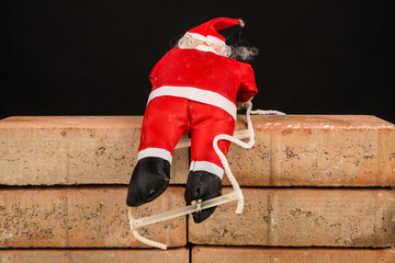 Santa trying to climb the wall, a concept on immigration policies.