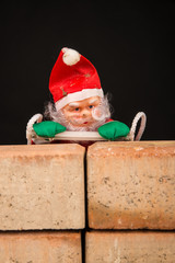 Santa trying to climb the wall, a concept on immigration policies.