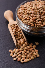 raw lentils on a dark stone background
