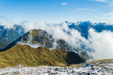 Mountain range with clouds coming up; Kepler rack, Fjordland, New Zealand