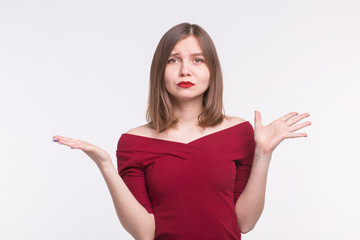 Feelings, emotions and people concept - Sad young woman in red top draw her hands