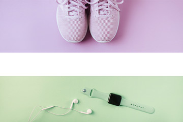 Violet sneakers, headphones and watcheson pink background.