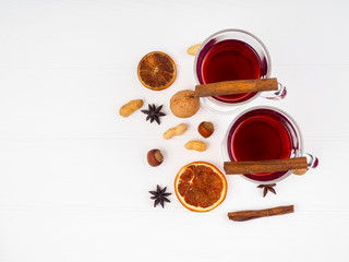 glass of mulled wine and spices on white background