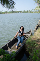 A beautiful Women sitting on a boat in Kerala Backwaters