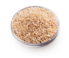 Bowl with barley grits isolated on white