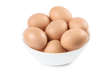 White plate full of brown eggs, isolated on white background