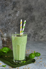 Vegetable smoothies from yogurt, spinach, basil and avocado with chia seeds on a concrete background. Detox drink. Proper nutrition.