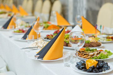 banquet hall of the restaurant, beautifully decorated tables with food	